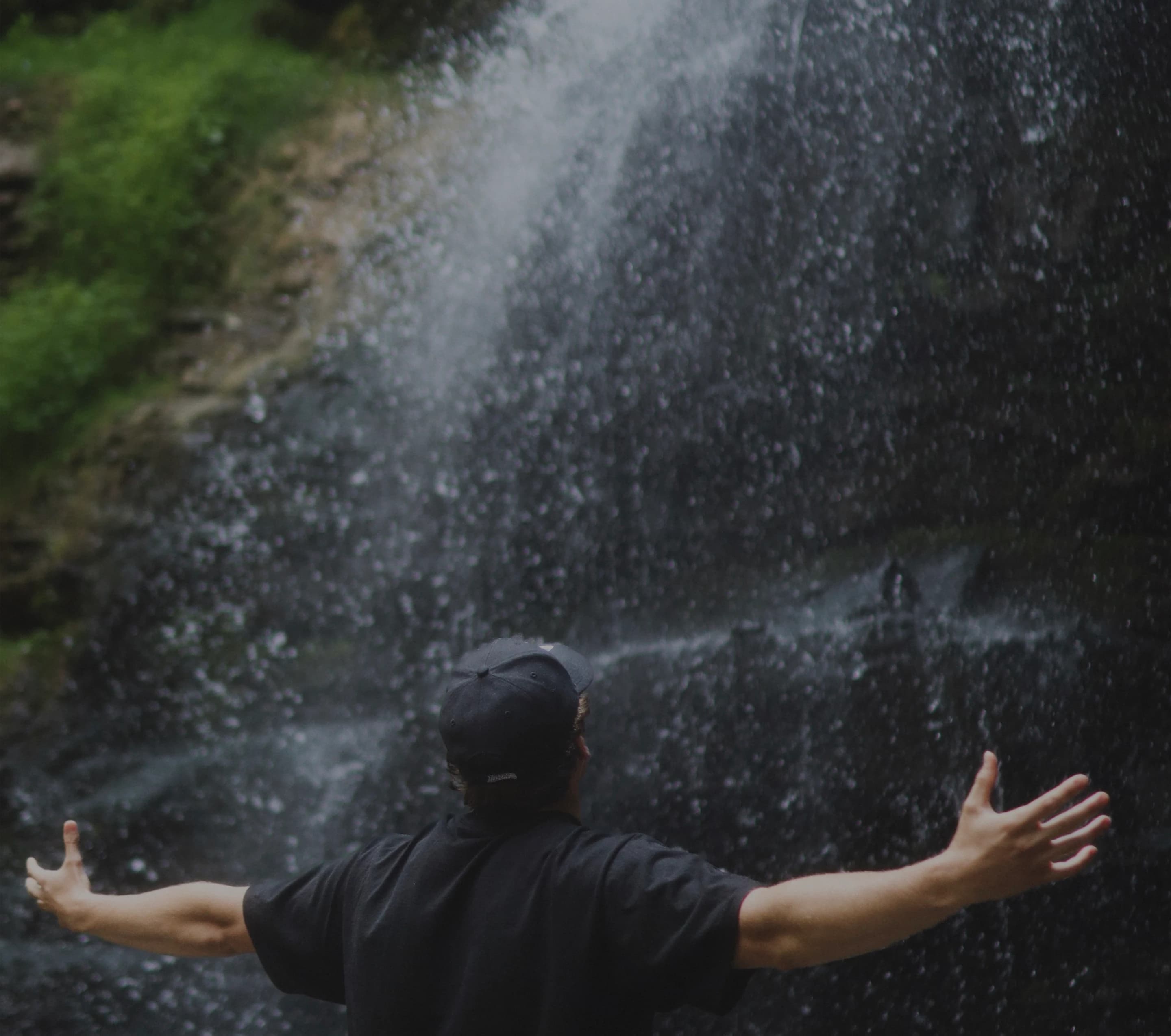 Cross facing a waterfall